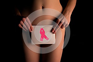 naked woman shows pink cancer awarness symbol