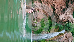 Naked woman swimming lagoon in beautiful summer nature vertically. Lady in lake