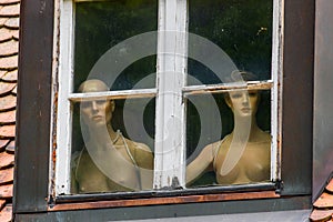 Naked women behind a window