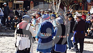 Nakhi women dance around the square in Lijiang
