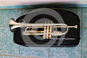 Nakhon Sawan, Thailand, on May 8, 2019, a silver trumpet blowing instrument placed on a black box.  On the tile floor