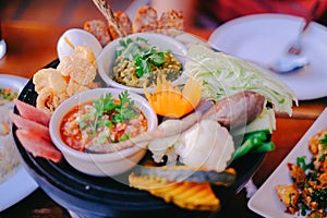 Nam Prik Num Northern Thai Green Chilli Dip eaten with pork crust and fresh vegetables, blanched vegetables.