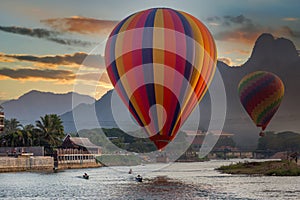 Nam Song river at sunset with hot air balloon in Vang Vieng, Laos, Beautifull landscape on the Nam Song River in Vang Vieng, Laos