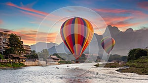 Nam Song river at sunset with hot air balloon in Vang Vieng, Laos, Beautifull landscape on the Nam Song River in Vang Vieng, Laos