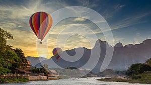 Nam Song river at sunset with hot air balloon in Vang Vieng, Laos, Beautifull landscape on the Nam Song River in Vang Vieng, Laos