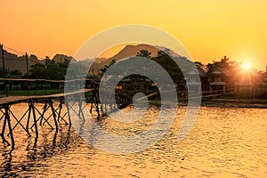 Nam Song River with wooden bridge at sunset in Vang Vieng, Laos