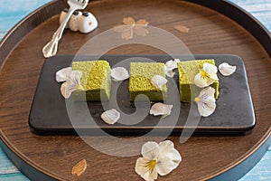 Nama Matcha Chocolate With Edible Flowers on a Traditional Wooden Tray