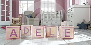 The name adele written with wooden toy cubes in children`s room