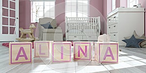 The name alina written with wooden toy cubes in children`s room photo
