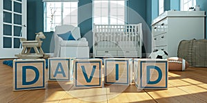 The name david written with wooden toy cubes in children`s room