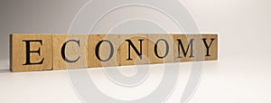 The name Economy was created from wooden letter cubes. Economics and finance.