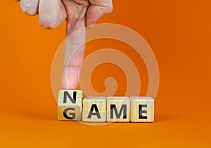 Name of the game symbol. Wooden blocks with concept words Name Game. Businessman hand. Beautiful orange table orange background.