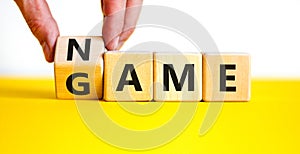 Name of the game symbol. Wooden blocks with concept words Name Game. Businessman hand. Beautiful yellow table white background.