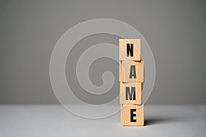 Name inscription on wooden blocks concept. Creation of a new personal brand or name for a business company. Logo, marketing.
