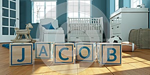 The name jacob written with wooden toy cubes in children`s room