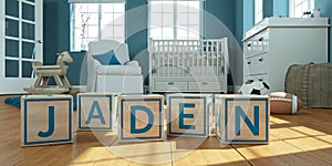 The name jaden written with wooden toy cubes in children`s room photo