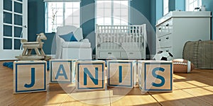 The name janis written with wooden toy cubes in children`s room