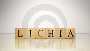 The name Lichia was created from wooden letter cubes. Seafood and food. photo