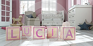 The name lucia written with wooden toy cubes in children`s room