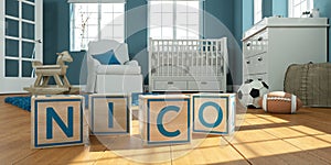 The name nico written with wooden toy cubes in children`s room