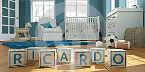 The name ricardo written with wooden toy cubes in children`s room