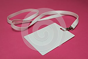 Name tag with white neckband isolated on pink background