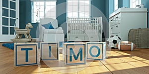 The name timo written with wooden toy cubes in children`s room photo