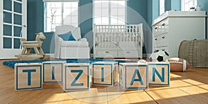 The name tizian written with wooden toy cubes in children`s room