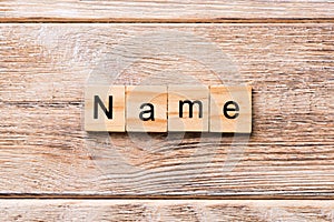 NAME word written on wood block. NAME text on wooden table for your desing, concept
