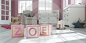 The name zoe written with wooden toy cubes in children`s room