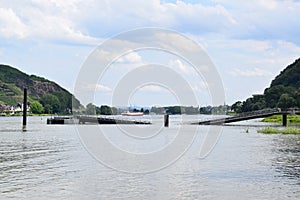 Namedy, Germany - 06 29 2021: Rhine with crashed bridge at Namedyer Werth and a ship in the far