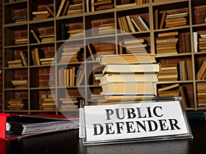 Nameplate public defender and stack of book. photo