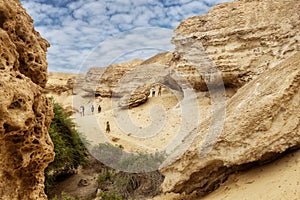 NAMIBE/ANGOLA - 03NOV2018 - Tourists walking in the canyons of the Namibe Desert. Africa. Angola