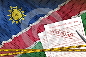 Namibia flag and Health insurance claim form with covid-19 stamp. Coronavirus or 2019-nCov virus concept