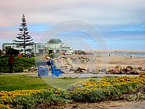 Namibia, Swakopmund, Blue Park Bench on Coastline