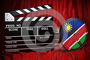Namibian cinematography, film industry, cinema in Namibia. Clapperboard with and film reels on the red fabric, 3D rendering