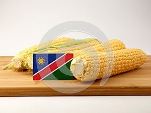 Namibian flag on a wooden panel with corn isolated on a white ba