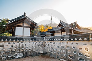 Namsangol Hanok Village, Korean traditional house and Namsan Seoul Tower at autumn in Seoul photo