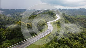 Nan, Thailand. Aerial view of Beautiful sky road over top of mountains with green jungle. Road trip on curve road in mountain.