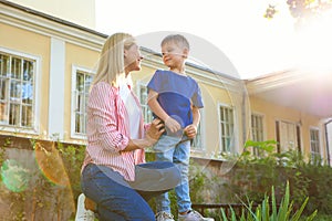 Nanny with cute little boy outdoors on sunny day