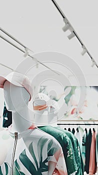 Nano-engineered clothing on mannequins, futuristic design, sharp lighting, wide angle, clean graphic style photo