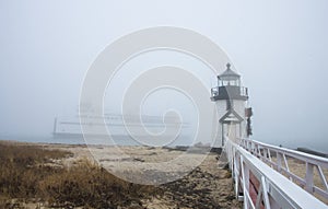 The Nantucket Island ferry boat sails past the Brant Point Lighthouse in fog