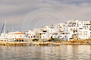 Naoussa coastal village Paros Island landscape view during golden hour with typical whitewashed cycladic houses, Greece