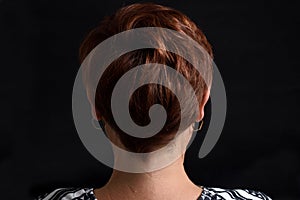 Nape of middle aged woman on black