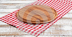 Napkin and board for pizza on wooden desk closeup, tablecloth. Canvas, dish towels on white wooden table background top view mock