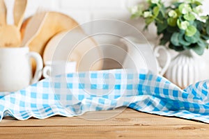 Napkin checkered tablecloth on brown wooden kitchen table. Blur rye bokeh background. Selective focus. Place for food