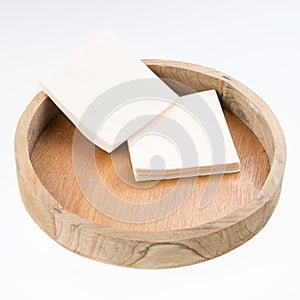 Napkins on round wooden tray