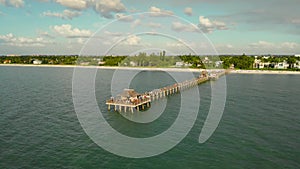 Naples beach and fishing pier at sunset, Florida.