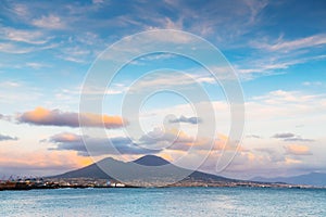 Naples city and Gulf of Naples, Italy. Vesuvius volcano with pink clouds at sunset