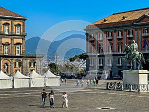 Monumental Plebiscite Square in Naples, Italy, with historic buildings and the outline of the Vesevius volcano